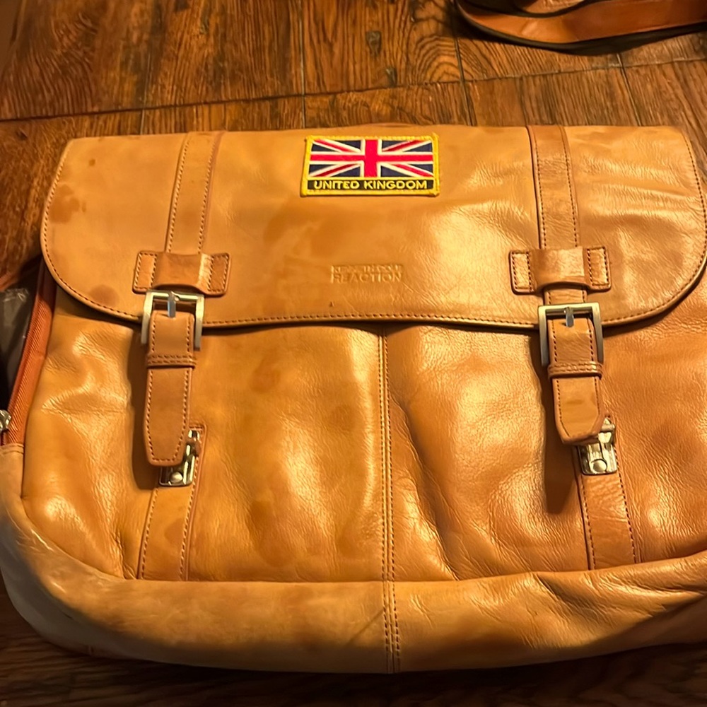 Kenneth Cole slight faded vintage look . some spots from another leather bag.